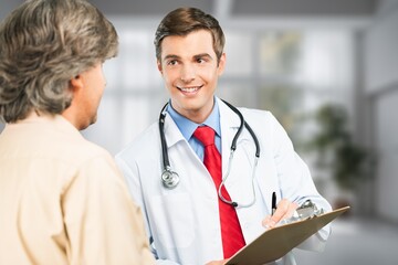 Happy doctor consulting patient in hospital