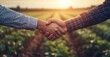 © PHOTOS  STORY - Handshake between two individuals, one in business attire and the other in farmer's clothing, set against an open field background.