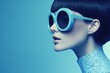 © volga - Fashionable young adult woman with stylish sunglasses on blue background