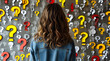 © GAmedia - The girl stands in front of a wall covered with question marks. A brain attack.