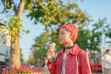 Traveler Gen z girl leather fashion with punk Asian woman tourist of local city Southeast Asia travel enjoying ice cream in summer hot weather