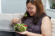 © Charlie's - Asian Overweight woman dieting Weight loss eating fresh fresh homemade salad healthy eating concept Obese Woman with weight diet lifestyle.