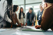 © Jacob Lund - Diverse team brainstorming during a business meeting in a modern office