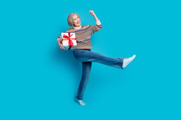 Canvas Print - Full length photo of satisfied person wear jeans holding present scream yes look at sale empty space isolated on blue color background