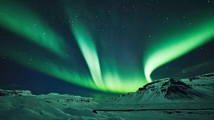 Wall Mural - The Aurora Borealis dances across the night sky over a snow-covered landscape in Iceland