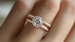 © Helois - A close-up of a woman's hand wearing a beautiful diamond engagement ring.