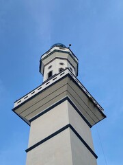 mosque pillar pole, Islamic religion and architecture concept, ornament of a mosque against blue sky.