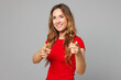 © ViDi Studio - Young smiling cheerful positive happy woman wear red t-shirt casual clothes point index finger camera on you motivating encourage isolated on plain grey background studio portrait. Lifestyle concept.