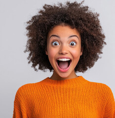 happy and surprised woman wearing orange sweater 