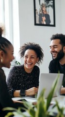 Poster - Three people are sitting around a table with laptops and smiling