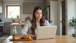 © Dmitry - Woman Working on Laptop in Kitchen with Healthy Meal