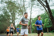 © Odua Images - sporty man running through marathon track with other athlete