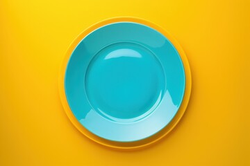 Bright blue plate resting on a yellow background, showcasing minimalist design and vibrant colors