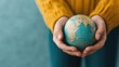 © supansa - A close-up of hands holding a globe, symbolizing global unity and the collective effort of volunteers worldwide, [International Volunteer Day], [global impact, unity], ,