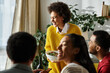 © LIGHTFIELD STUDIOS - Friends enjoy a festive Thanksgiving gathering filled with laughter, food, and warmth.