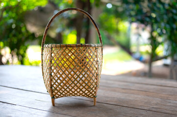 Close up Native of bamboo basket with countryside background.Thai Handicraft Products : Rattan and Bamboo Wickerwork line up on blurred background.Treditional handmade product concept.