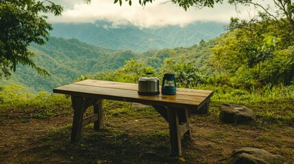 Sticker - Simple wooden table and portable camping stove, surrounded by lush mountain landscape.