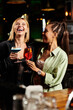 © LIGHTFIELD STUDIOS - Colleagues share laughter and drinks, enjoying a vibrant corporate celebration with friends.