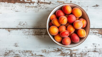 Poster - Bowl of Delicious Apricots on a White Wooden Surface