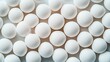 © altitudevisual - A close-up image of multiple white textured balls arranged in a grid-like pattern, creating a uniform and repetitive visual effect.