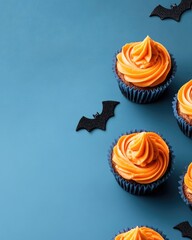 Wall Mural - Halloween themed cupcakes on blue backdrop for minimal party design with empty space