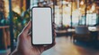 © AH TAR STOCK - cell phone blank white screen mockup.hand holding texting using mobile on desk at office.background empty space for advertise.work people contact marketing business,technology