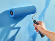 © Jan - Painting a bright blue wall with a roller