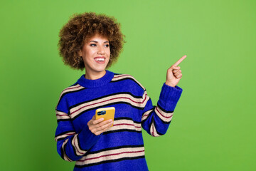 Canvas Print - Photo of charming nice woman wear blue striped stylish clothes promote modern device empty space isolated on green color background