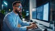 © สนิท เกษแก้ว - A focused man works on a computer, analyzing data in a modern office environment, showcasing technology and productivity.