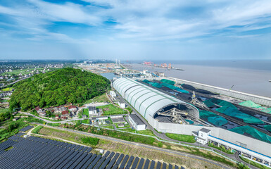 Sticker - Coal warehouses and solar panels in port by sea