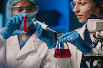 Wall Mural - team of biochemical research scientists working with a microscope for vaccine development