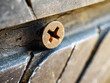 © NARONG - Close-up of a rusty screw driving into a car tire causing a puncture.