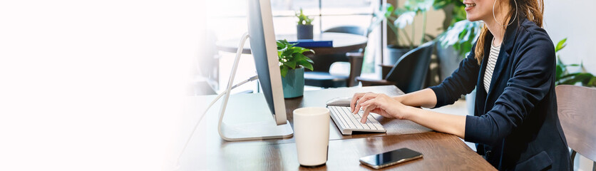 closeup hands business asian designer woman with suit working office desk using phone computer. smal