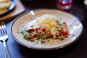 Wall Mural - Plate with with chicken, vegetables and grated cheese close up