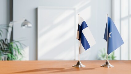 FLAGS OF FINLAND AND SOMALIA ON TABLE