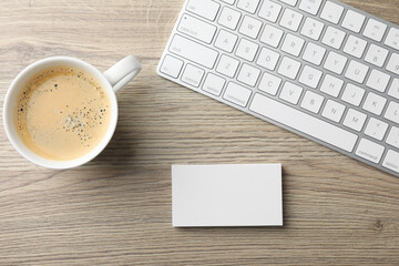 Sticker - Blank business cards, coffee and keyboard on wooden table, flat lay. Mockup for design