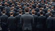 © StockUp - An individual stands above a large group of men in dark suits stand together, facing forward, in a formal and serious crowd.