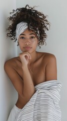 Wall Mural - A woman with curly hair is wearing a white and black striped scarf