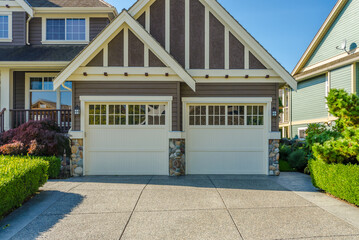 Garage door in luxury house with trees and nice landscape in Vancouver, Canada