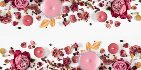 Wall Mural - autumn composition with dry roses and candles. autumn background in pastel color with dried rose flo