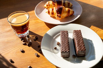 breakfast with coffee and croissant on wooden background