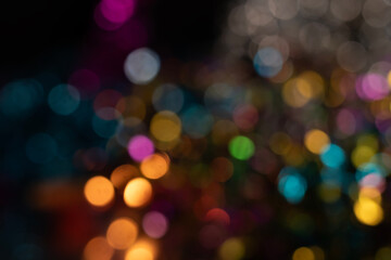 Multicolored abstract bokeh background with vibrant light circles.