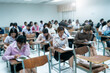 © EduLife Photos - A classroom filled with students taking an exam, captured with a blurred focus, symbolizing academic testing, education, and concentration.