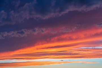 Wall Mural - glowing real sky at sunset texture background overlay. dramatic red and orange clouds.