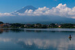 © Larry - Title: Beautiful image of Mount Fuji shot across Lake Kawaguchi. The water is very reflective. The clouds floating past the mountain makes this look like a magical image. This was taken is Fujiyoshida