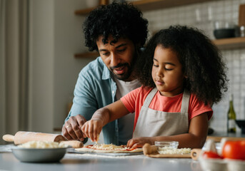 Wall Mural - Father and daughter are carefully adding cheese to pizza dough while preparing a meal together