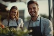 © Atlas Studio - Happy Young Man and Woman Working Together in a Vibrant Garden Center During the Golden Hour