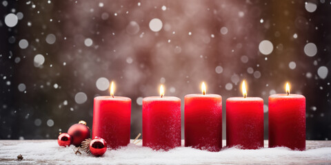 Red burning candles outside in the snow.Christmas feelings.