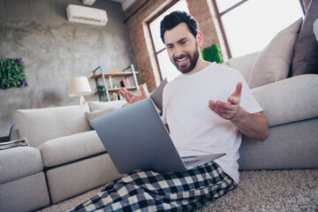 Sticker - Photo of smiling man wearing nightwear working remotely from home speaking modern device living room interior indoors