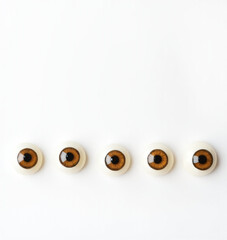 Poster - A set of five human eyes are depicted with brown irises, placed against a clean white backdrop in a simple yet lifelike manner._00001_